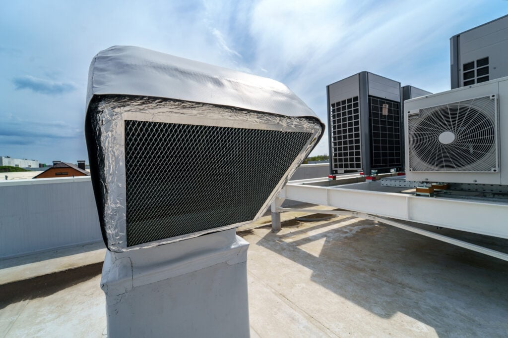 The air conditioning and ventilation system of a large industrial building is located on the roof. It consists of air ducts, air conditioning, smoke removal and ventilation