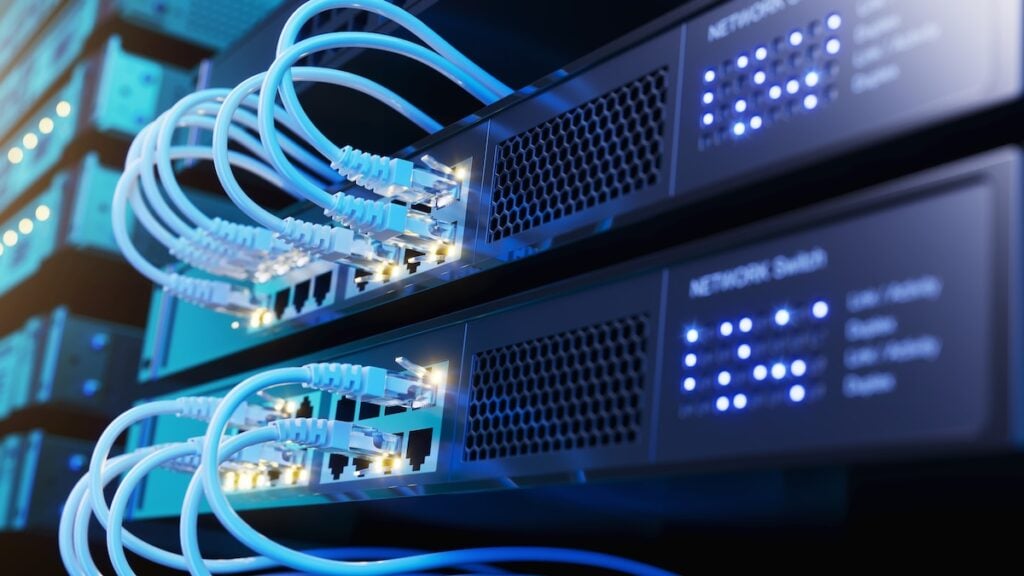 Network switch and network cables in modern server room data center.