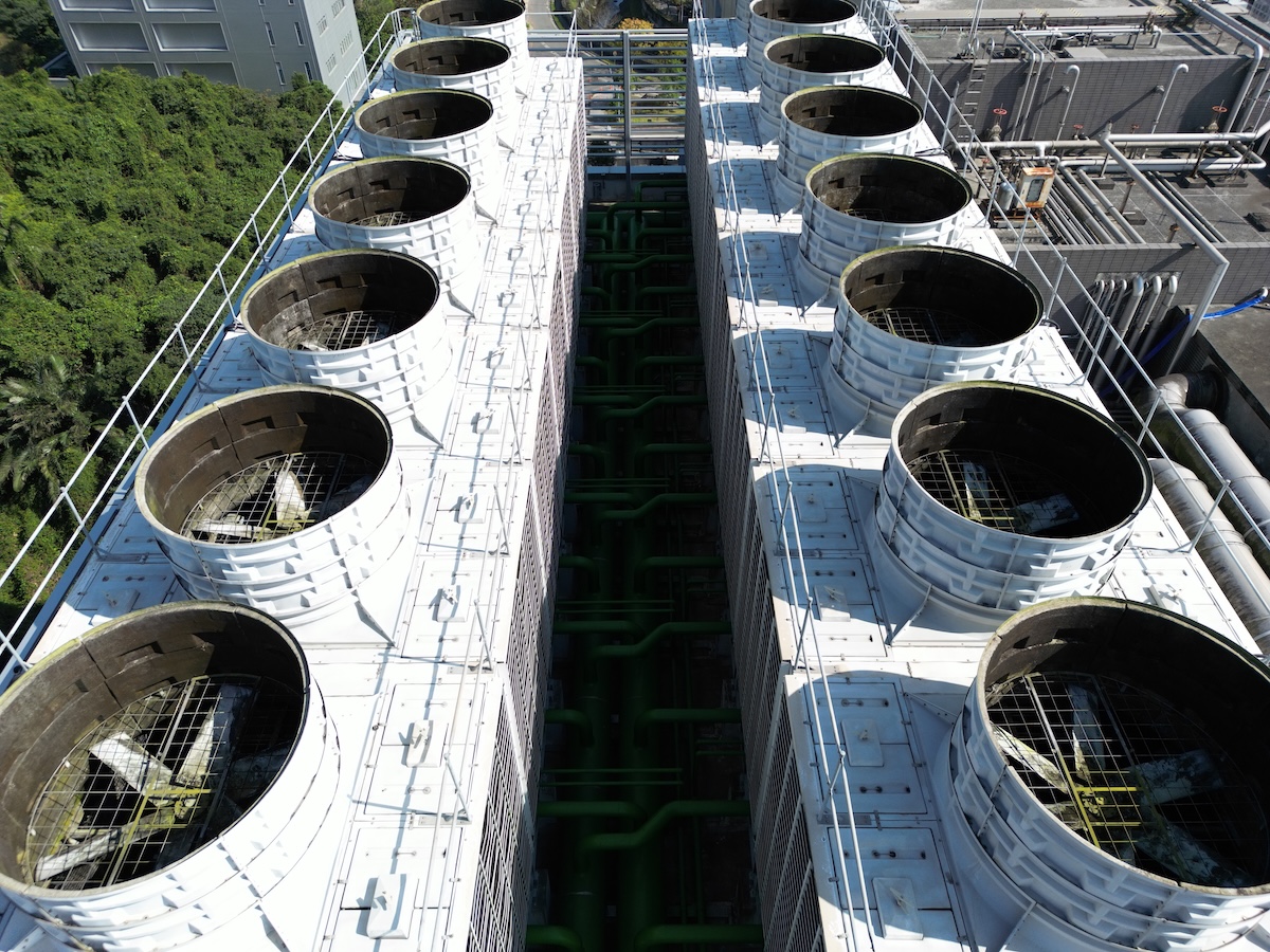 AI data center cooling towers next to forest.