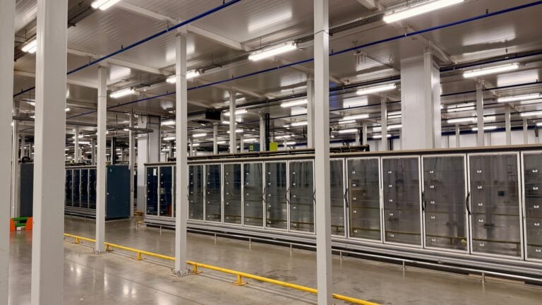 Modern data center interior with rows of server racks and cooling systems. High-tech cloud computing infrastructure room. Large enterprise network hardware, digital database storage warehouse.