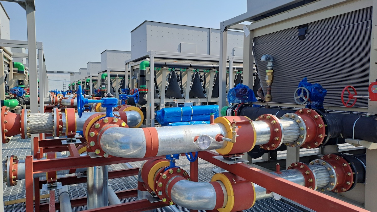 industrial cooling system and piping network on the rooftop of a modern data center under construction