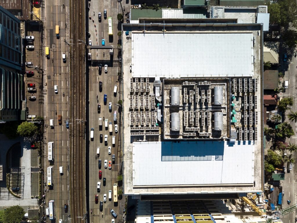 Top view of the roof deck of an office building, with installed VRF HVACs and water storage tanks.